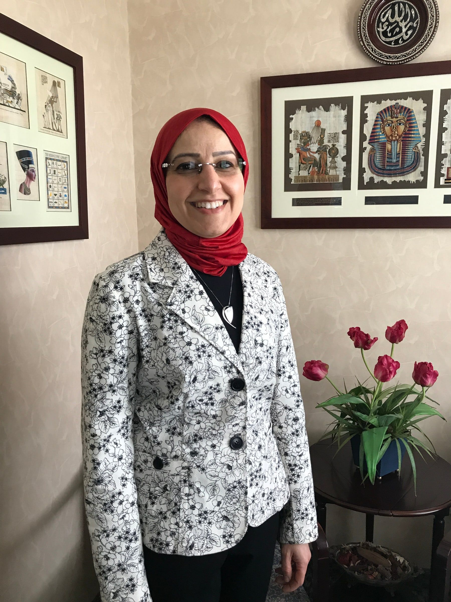 Dr. El-Refai smiling in her reception room in Medina