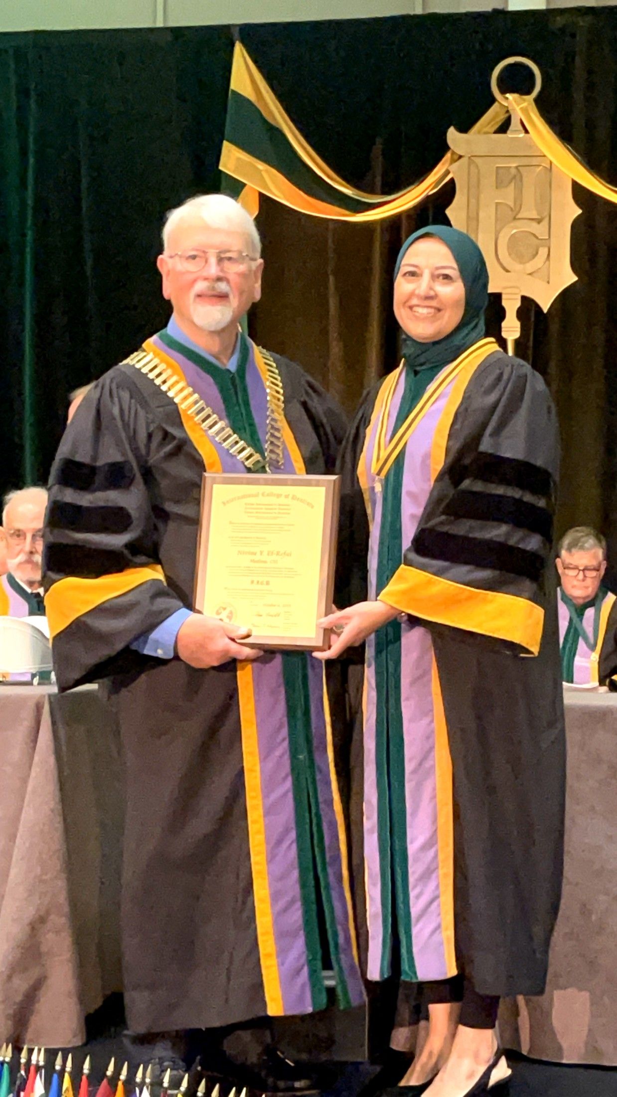 Dr. El-Refai receiving her fellowship certificate at the International College of Dentists convocation in 2023
